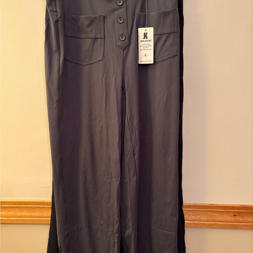 Black Women's wide leg yoga pants with button and pocket details.